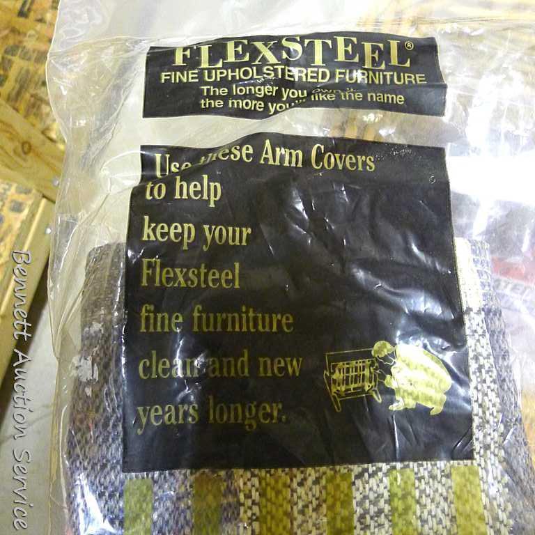 18" wide wicker basket filled with assorted cloth shopping bags, curtains, clay pot, etc.