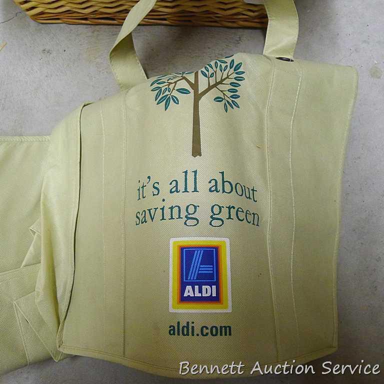 18" wide wicker basket filled with assorted cloth shopping bags, curtains, clay pot, etc.