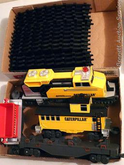 Caterpillar toy train set comes with track, engine, caboose and two other cars. Track pieces are