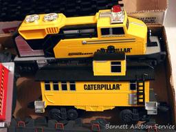 Caterpillar toy train set comes with track, engine, caboose and two other cars. Track pieces are