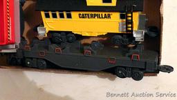 Caterpillar toy train set comes with track, engine, caboose and two other cars. Track pieces are