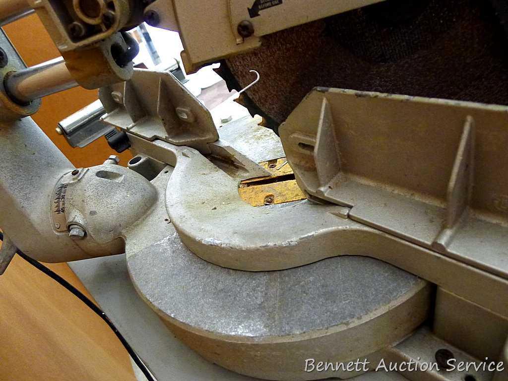 DeWalt 12" double bevel sliding compound miter saw is 36" long. It is bolted to a Ridgid AC9940