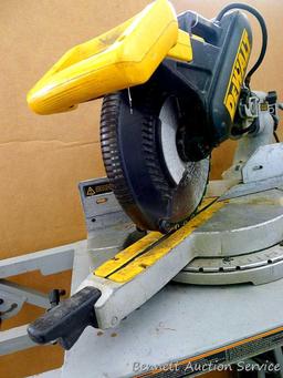 DeWalt 12" double bevel sliding compound miter saw is 36" long. It is bolted to a Ridgid AC9940