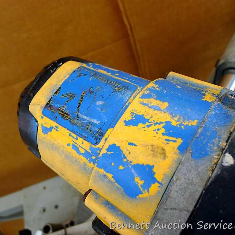 DeWalt 12" double bevel sliding compound miter saw is 36" long. It is bolted to a Ridgid AC9940