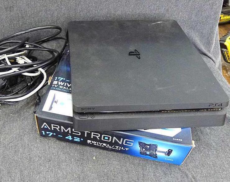 Sony Play Station 4, Armstrong 17"-42" swivel TV wall mount, and a bag of cords. PS4 turns on and is