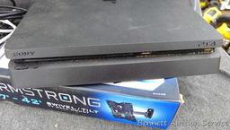 Sony Play Station 4, Armstrong 17"-42" swivel TV wall mount, and a bag of cords. PS4 turns on and is