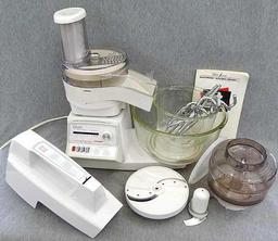 Oster "Kitchen Center" includes base, two bowls, beaters, mixer head, food processor head, and more.