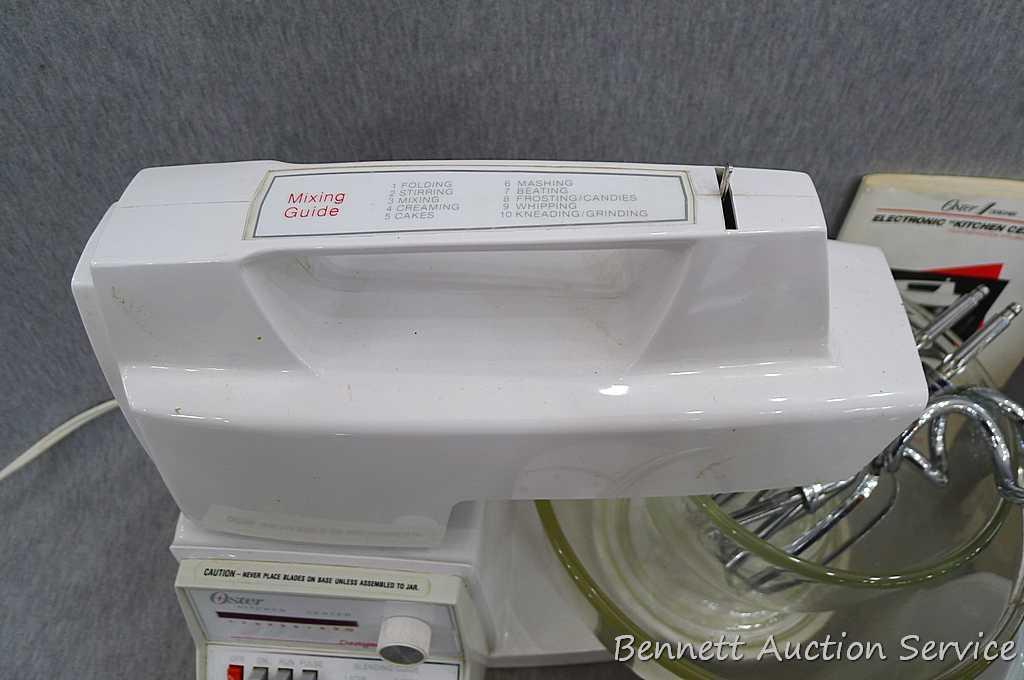Oster "Kitchen Center" includes base, two bowls, beaters, mixer head, food processor head, and more.