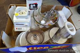 Oster "Kitchen Center" includes base, two bowls, beaters, mixer head, food processor head, and more.
