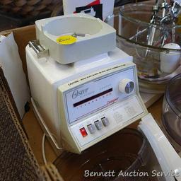 Oster "Kitchen Center" includes base, two bowls, beaters, mixer head, food processor head, and more.