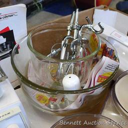 Oster "Kitchen Center" includes base, two bowls, beaters, mixer head, food processor head, and more.