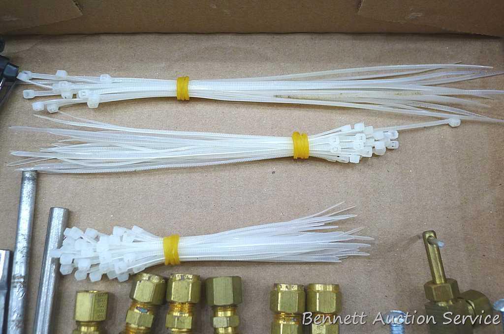 Self tapping saddle valve, zip ties, wire, saddle clamp, and copper tubing connectors. Longest zip