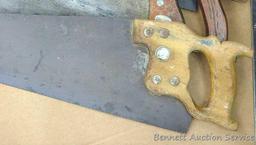 Four hand saws and square. Saws have some rust on blades and chips on handles. Longest saw measures