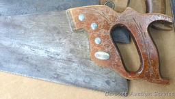 Four hand saws and square. Saws have some rust on blades and chips on handles. Longest saw measures