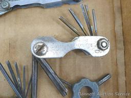 Craftsman and other feeler gauges, hex wrench sets, measuring tapes, plus a 3" miniature oil bottle.
