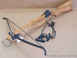Powermaster crossbow has a nice hardwood stock and is about 3' long overall, 32" wide. Back sight