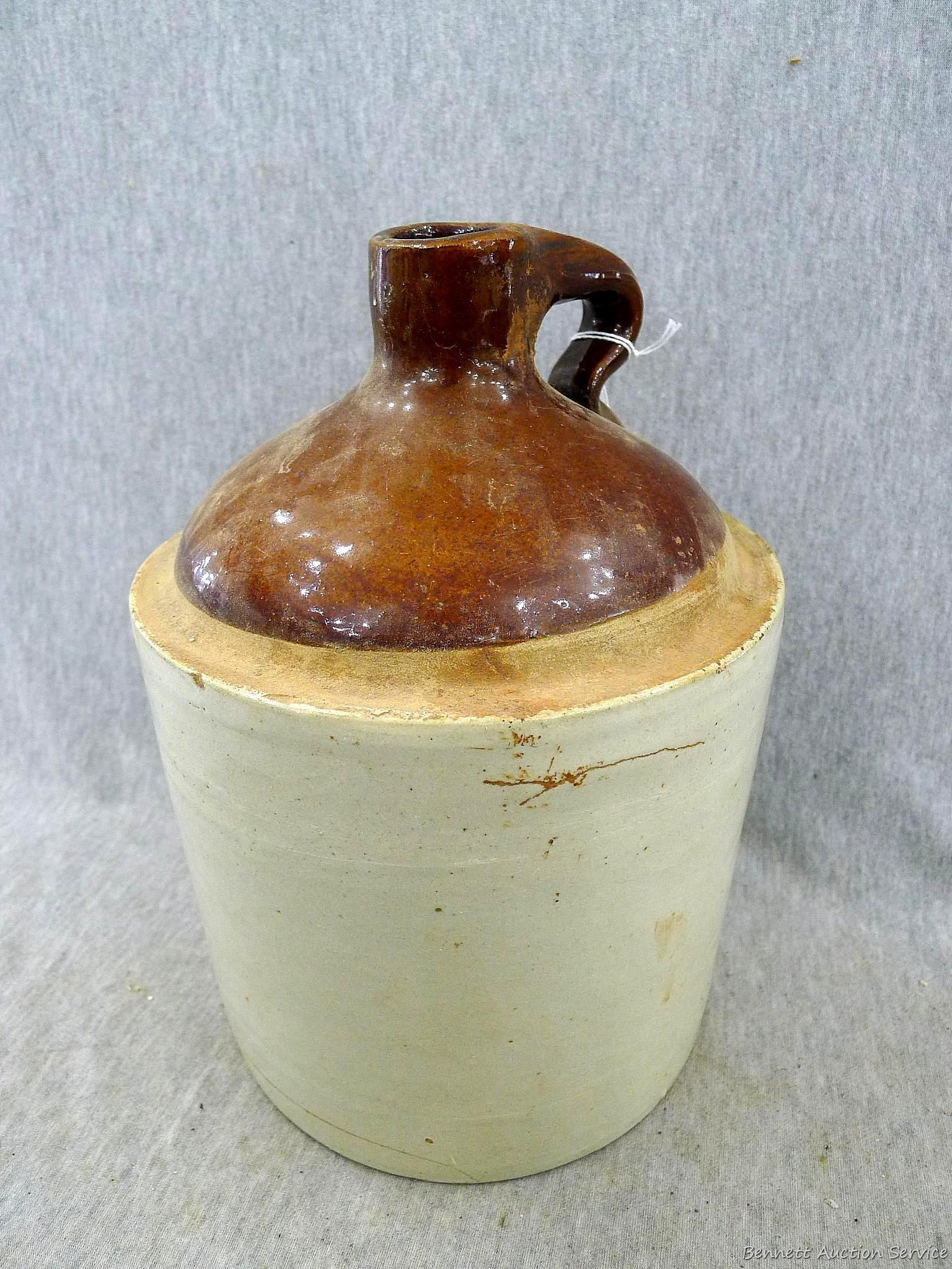 Stoneware jug stands nearly 11" overall.