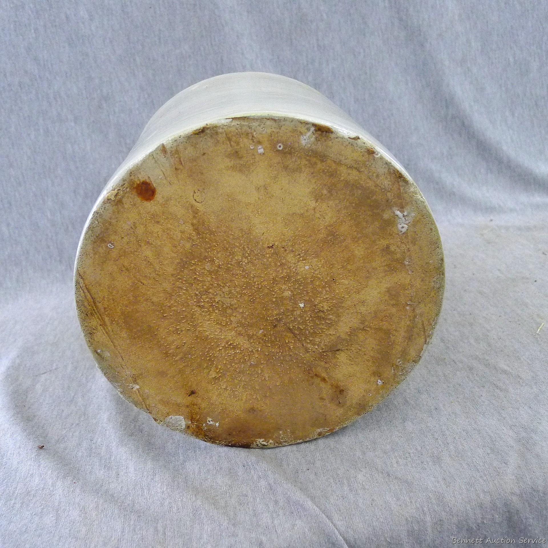 Stoneware jug stands nearly 11" overall.