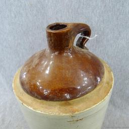 Stoneware jug stands nearly 11" overall.