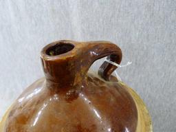 Stoneware jug stands nearly 11" overall.