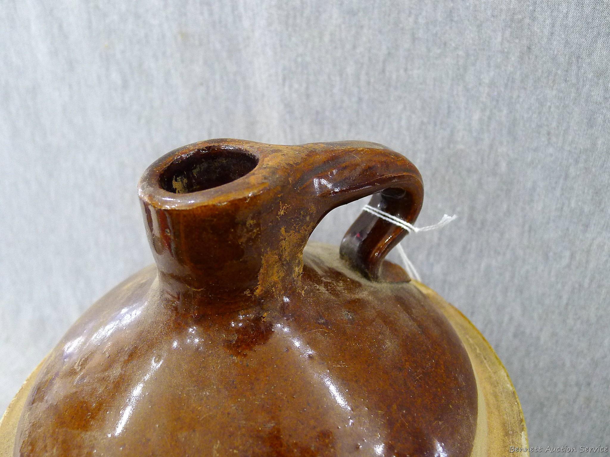 Stoneware jug stands nearly 11" overall.