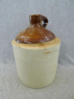 Stoneware jug stands nearly 11" overall.