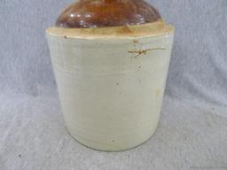 Stoneware jug stands nearly 11" overall.