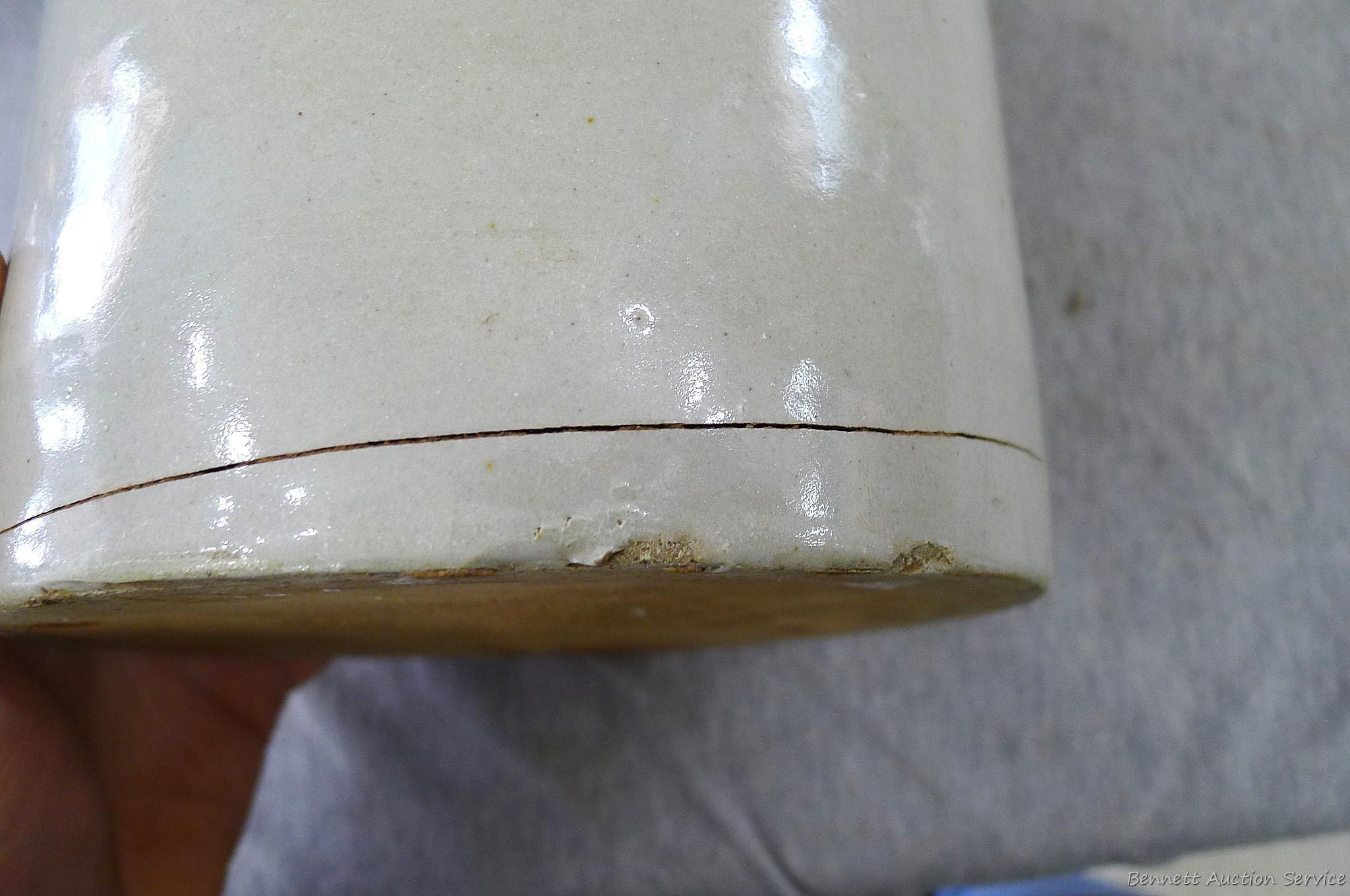 Stoneware jug stands nearly 11" overall.