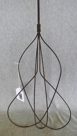 Antique rug beater is 33" long and in good shape.