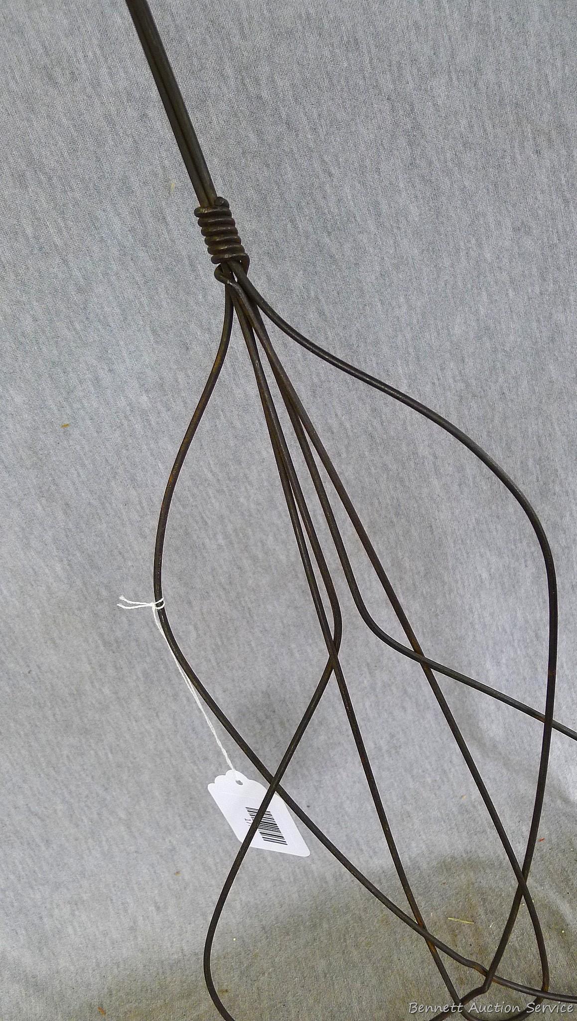 Antique rug beater is 33" long and in good shape.