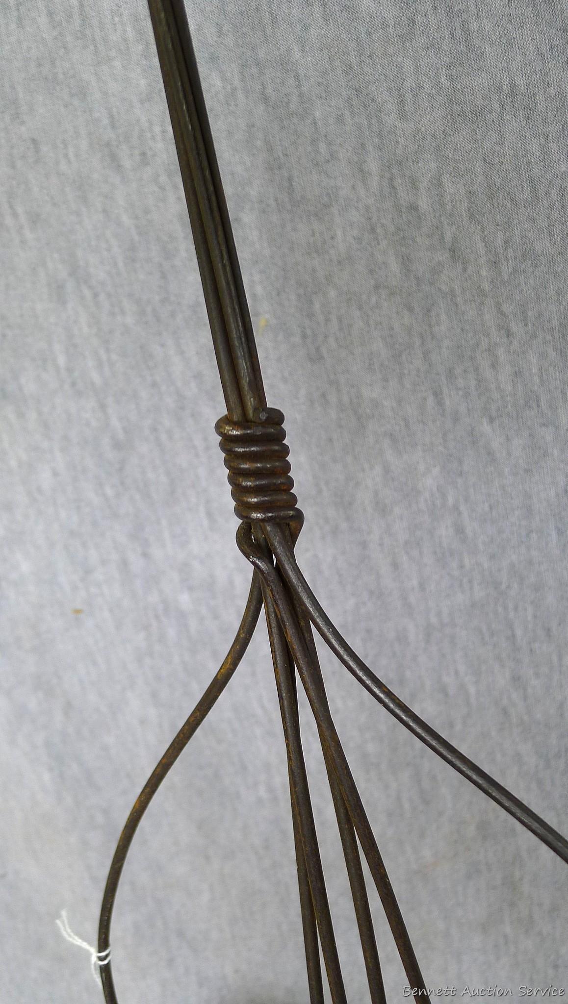 Antique rug beater is 33" long and in good shape.