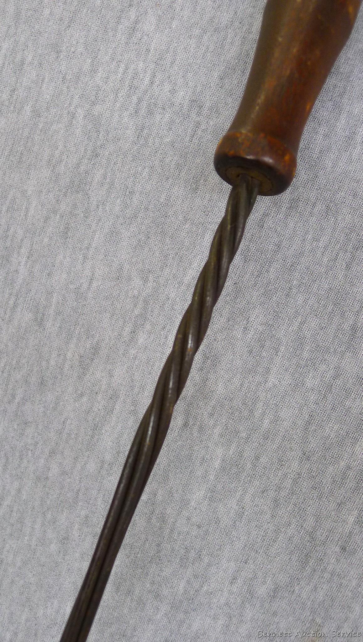 Antique rug beater is 33" long and in good shape.