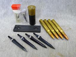Four .30-06 cartridges four unassembled broadheads, one 12 gauge shot shell.