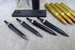 Four .30-06 cartridges four unassembled broadheads, one 12 gauge shot shell.
