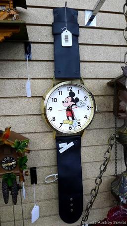Mickey Mouse watch electric wall clock; measures 9" x 37". Seller states it works, is missing the