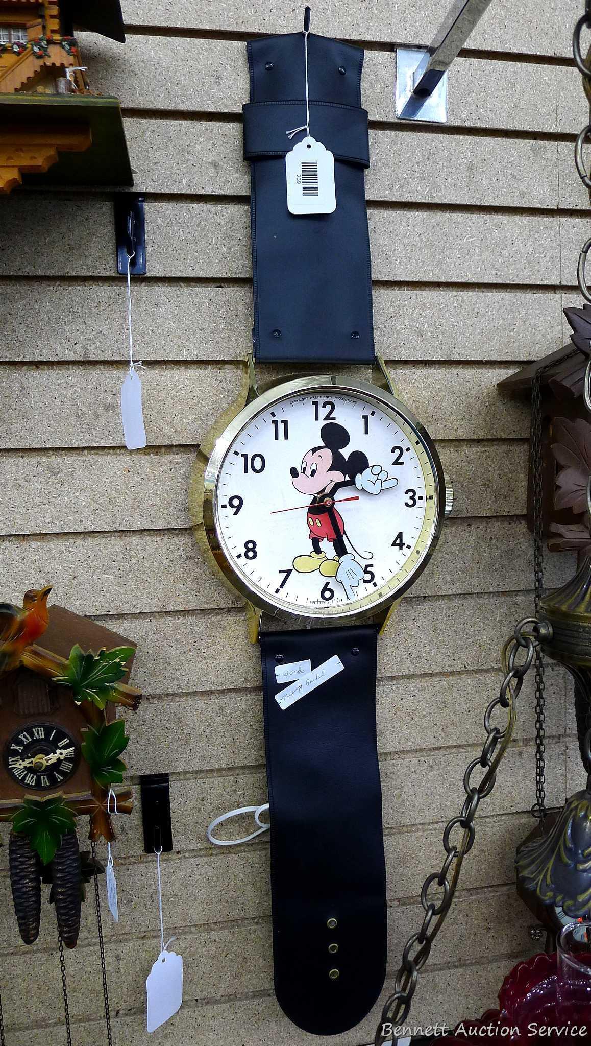 Mickey Mouse watch electric wall clock; measures 9" x 37". Seller states it works, is missing the