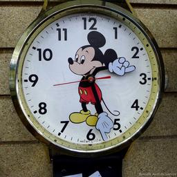 Mickey Mouse watch electric wall clock; measures 9" x 37". Seller states it works, is missing the