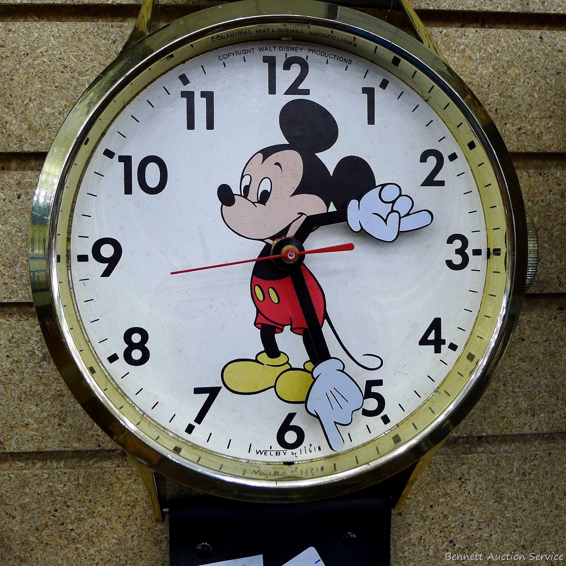 Mickey Mouse watch electric wall clock; measures 9" x 37". Seller states it works, is missing the