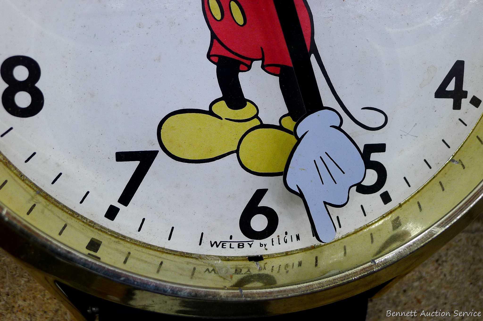 Mickey Mouse watch electric wall clock; measures 9" x 37". Seller states it works, is missing the