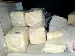 Large collection of disposable paper and cloth shop or cleaning rags.