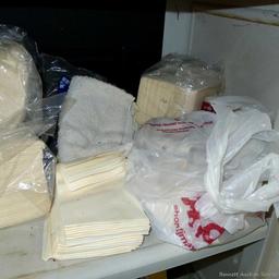 Large collection of disposable paper and cloth shop or cleaning rags.