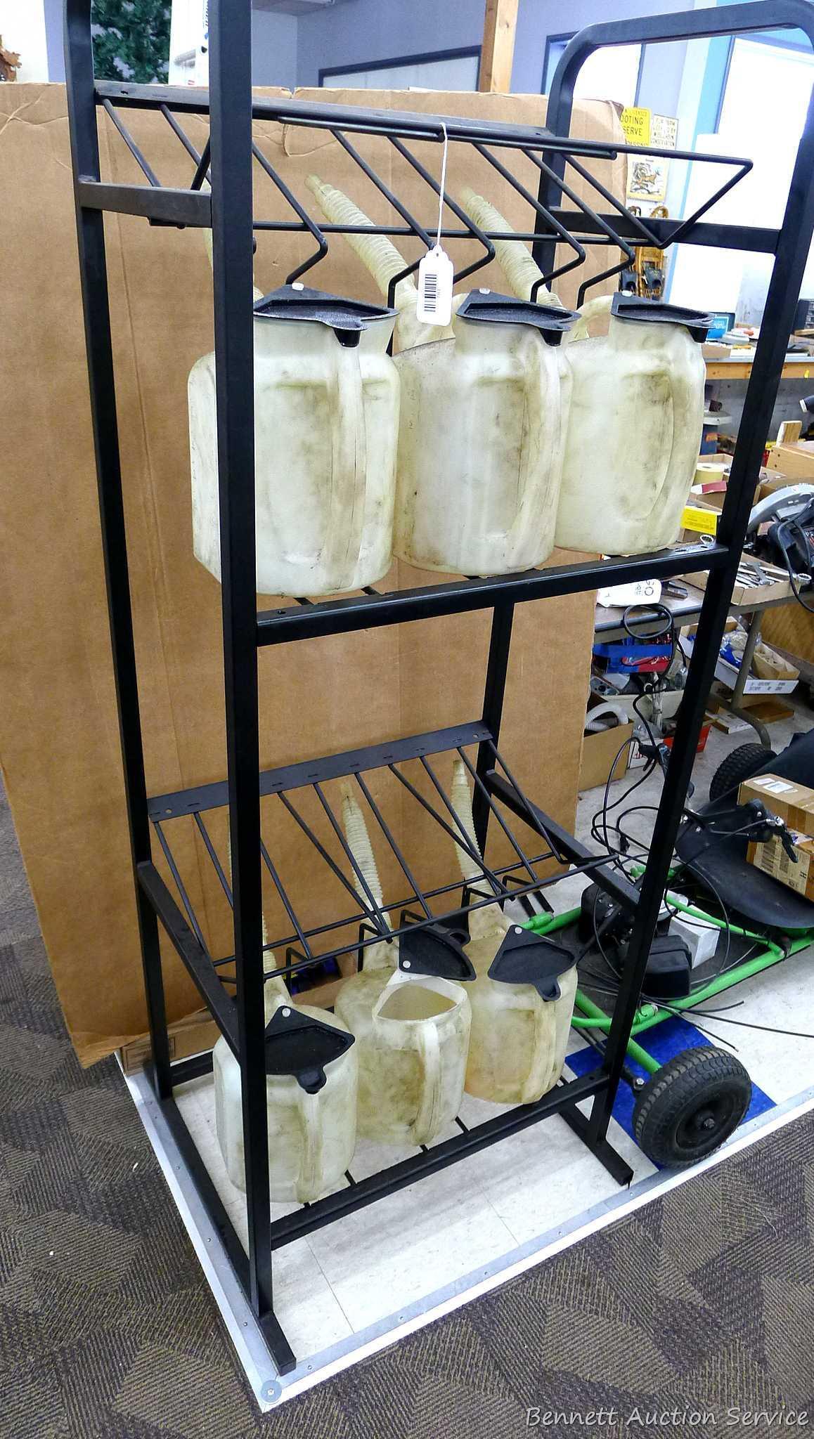 Automotive fluid jug organizer rack has space for twelve jugs - comes with 6 six quart dispenser