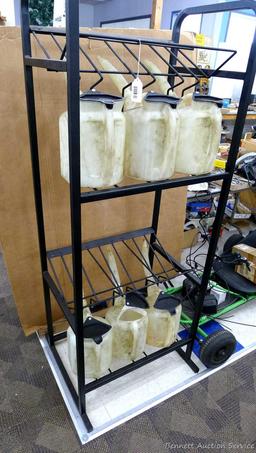 Automotive fluid jug organizer rack has space for twelve jugs - comes with 6 six quart dispenser
