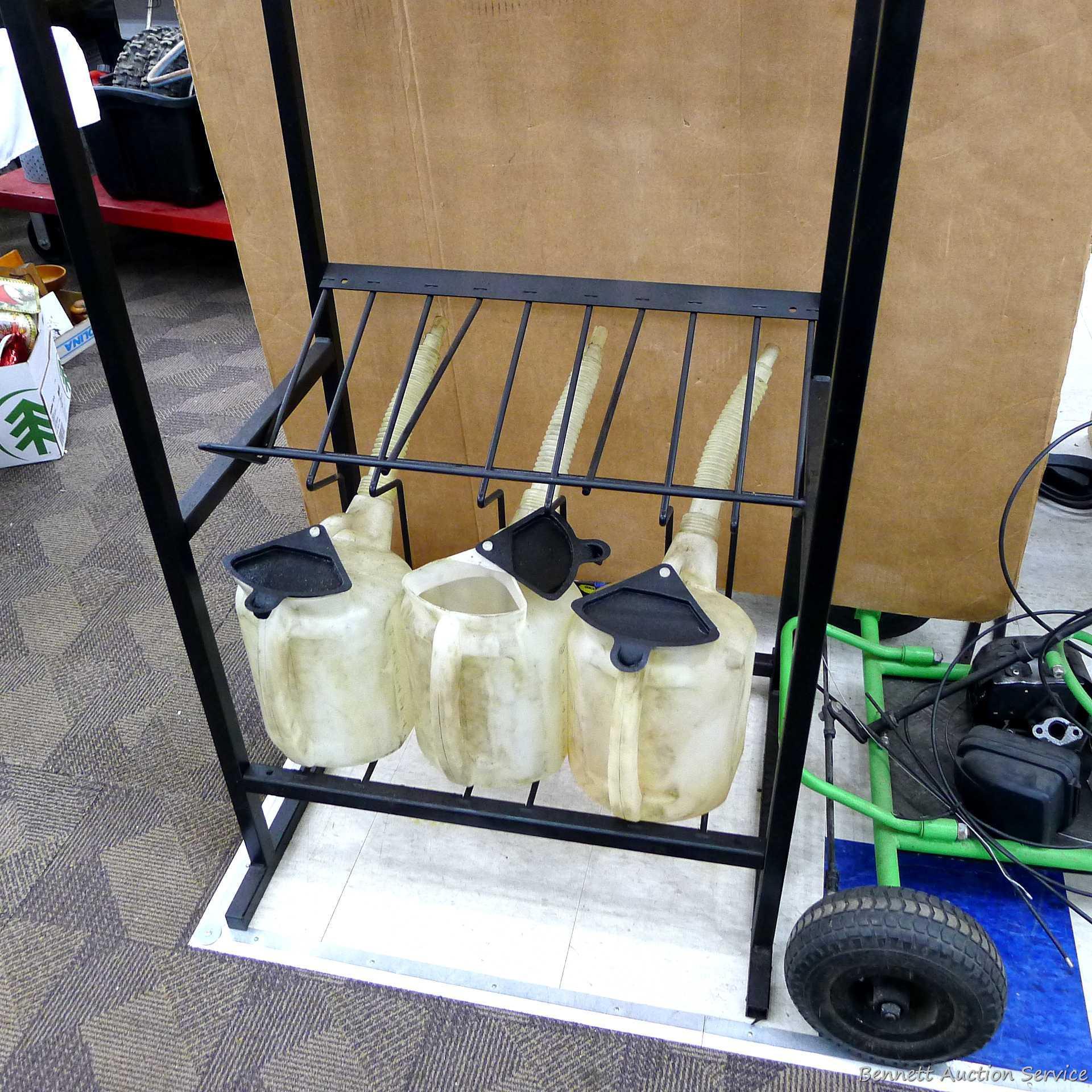 Automotive fluid jug organizer rack has space for twelve jugs - comes with 6 six quart dispenser
