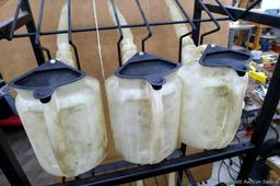 Automotive fluid jug organizer rack has space for twelve jugs - comes with 6 six quart dispenser