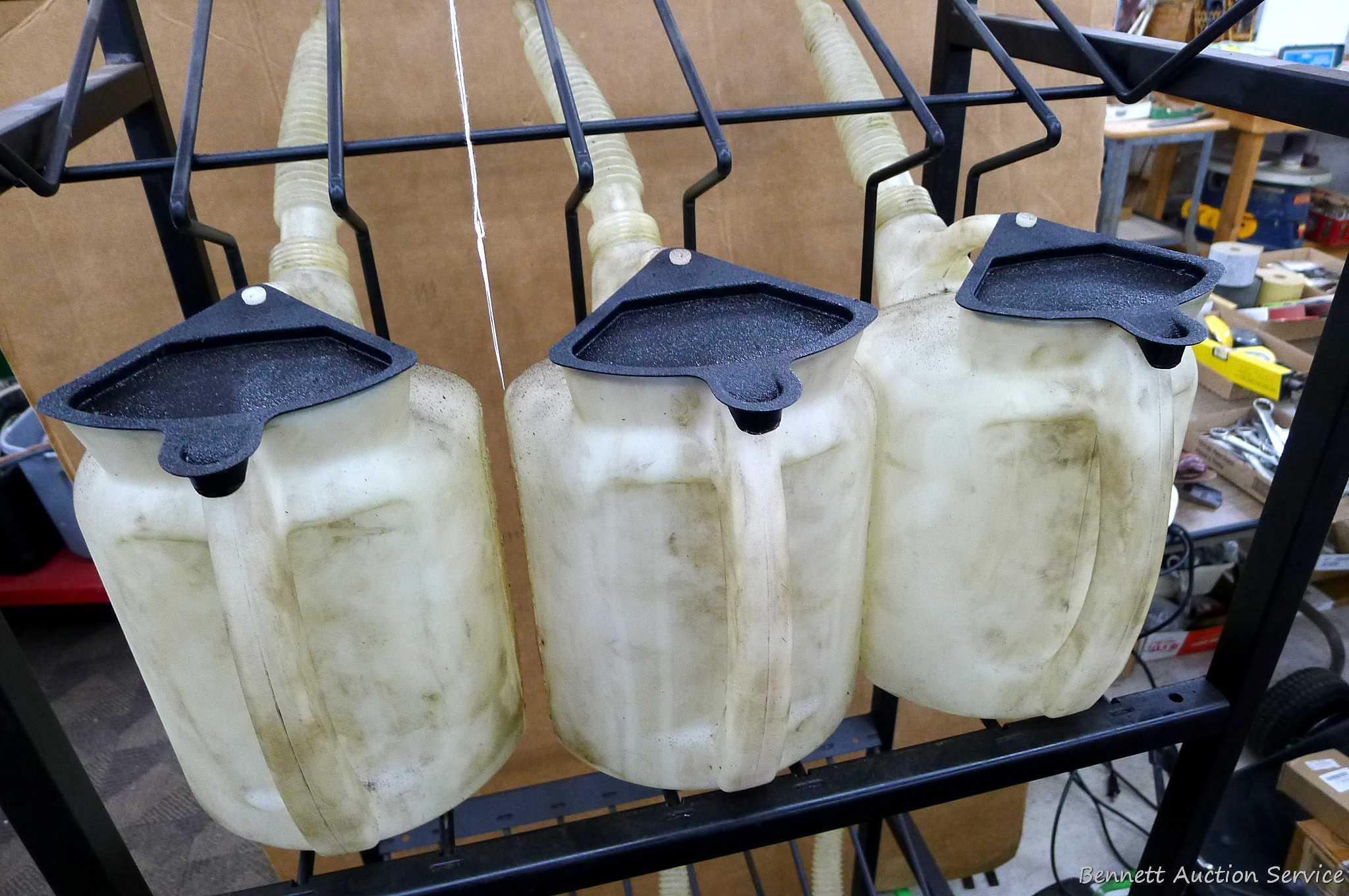 Automotive fluid jug organizer rack has space for twelve jugs - comes with 6 six quart dispenser
