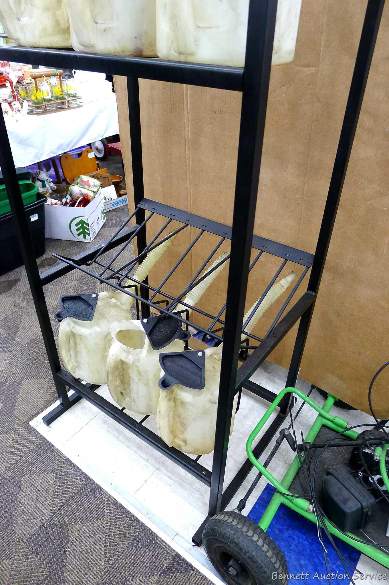 Automotive fluid jug organizer rack has space for twelve jugs - comes with 6 six quart dispenser