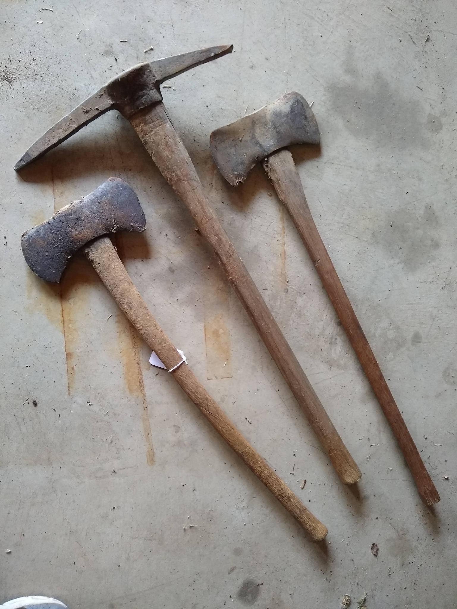 Two double bit axes and a double sided pick axe. Larger double bit axe has a 36" long handle and is