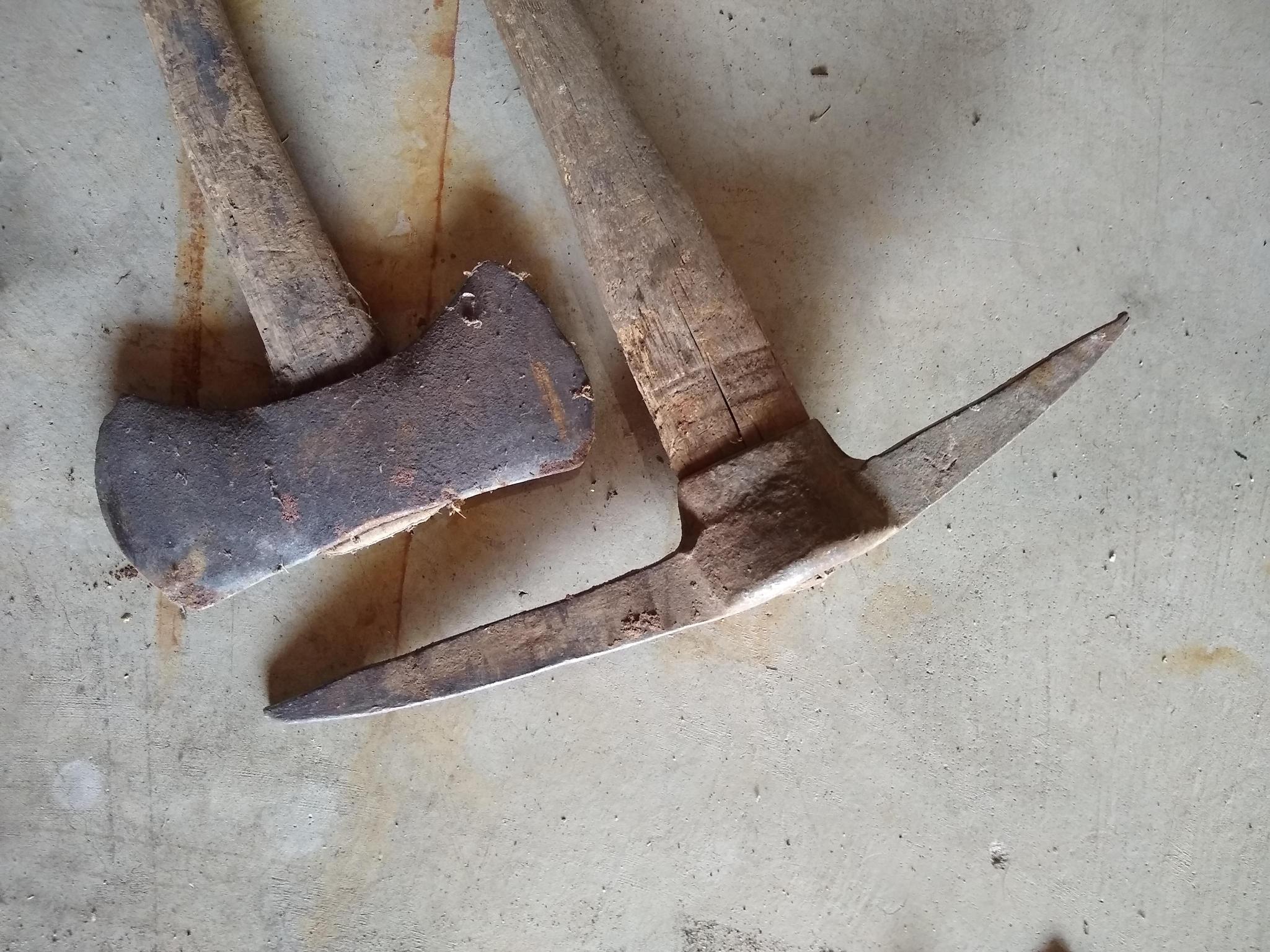 Two double bit axes and a double sided pick axe. Larger double bit axe has a 36" long handle and is