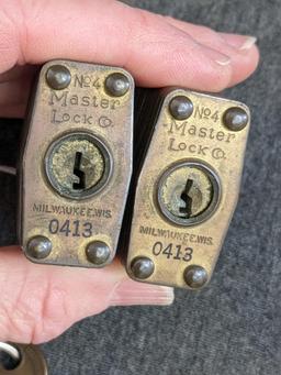 Pair of No. 4 brass Marine padlocks by Master Lock are keyed alike. About 2-1/4" long.